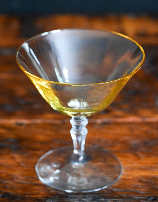 yellow champagne coupe with clear stem