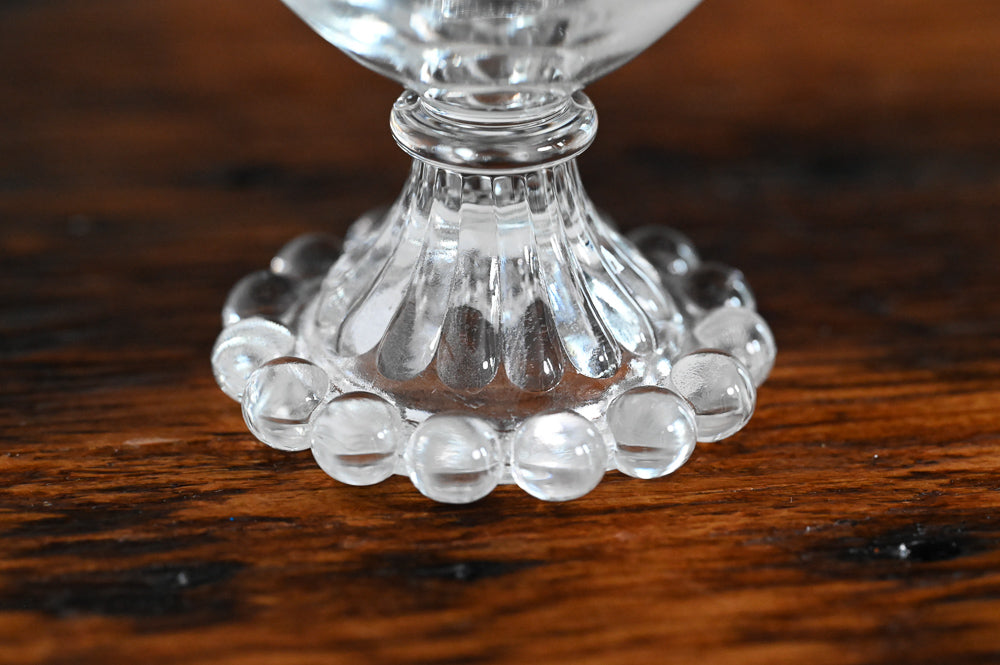 clear glass with glass balls on foot of glass