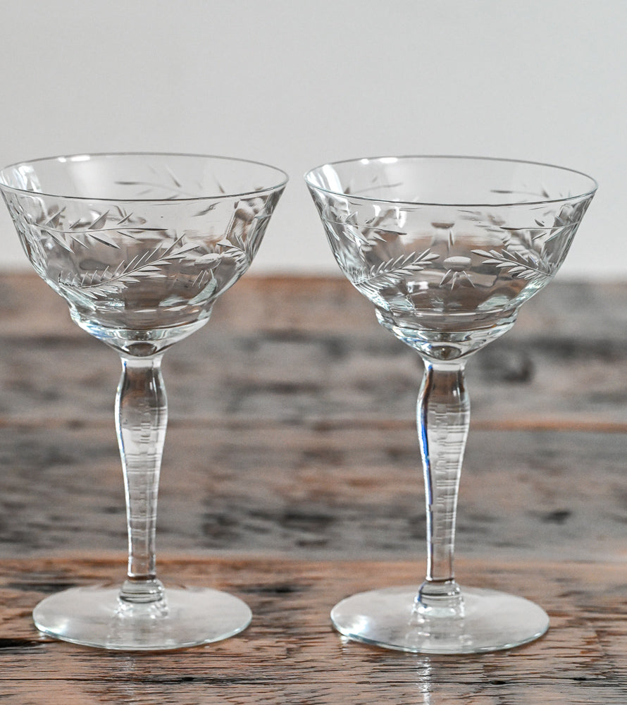 floral etched coupes on wood table