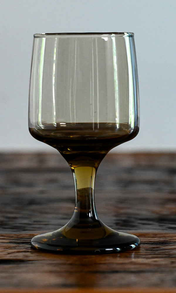 brown footed glass on wood table