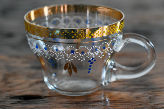 clear punch cup with gold rim, white and blue painted pattern