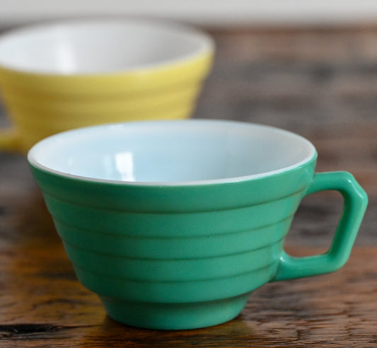 green square handled mug, yellow mug in background