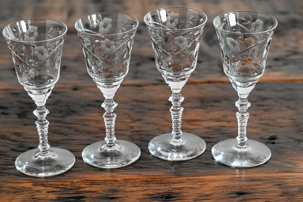 floral etched glasses on wood table
