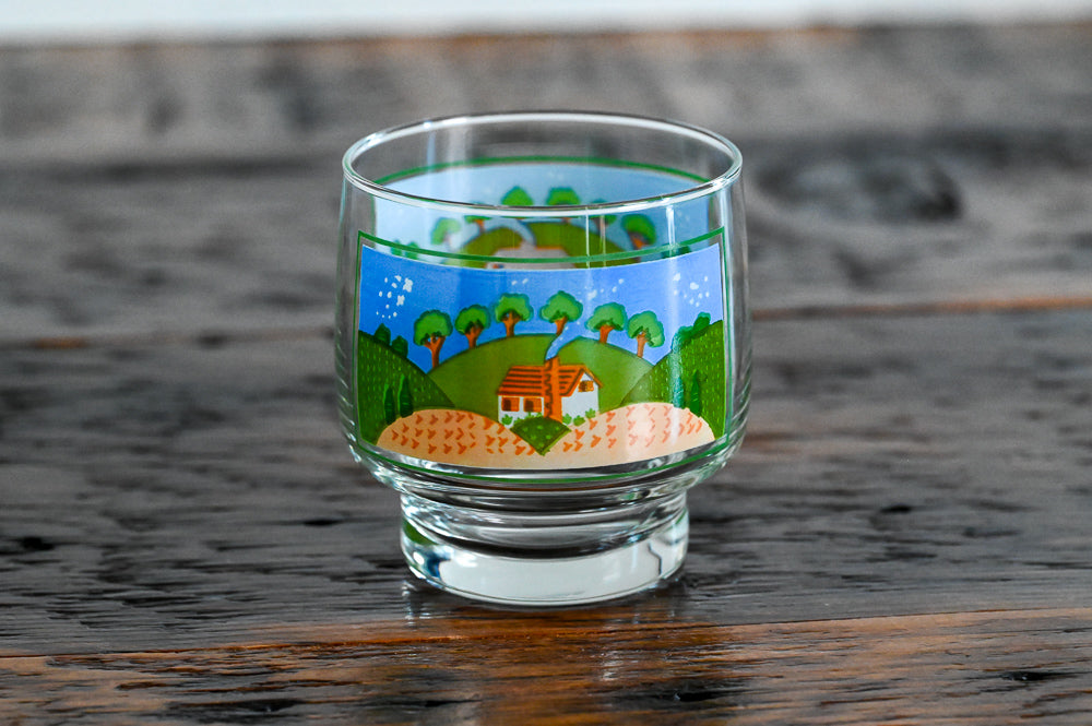 glass printed with farm scene on wood table