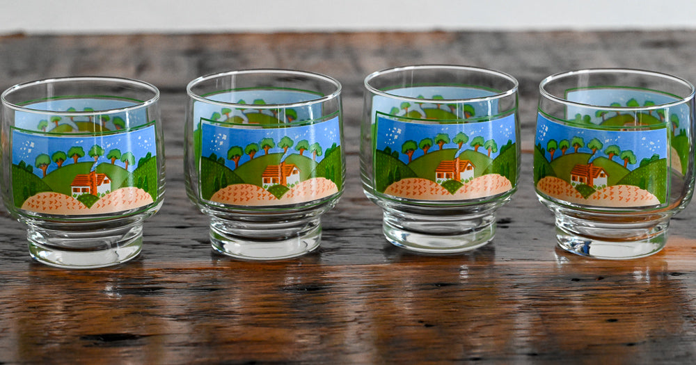 glasses printed with farm scene on wood table