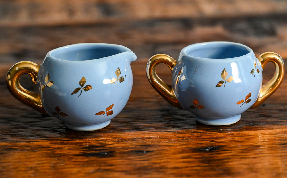 blue blue and gold leaf sugar and creamer set with gold handles