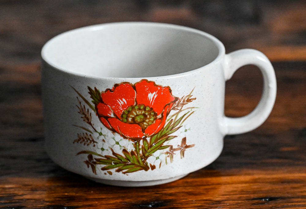 speckled stoneware mug with orange flower