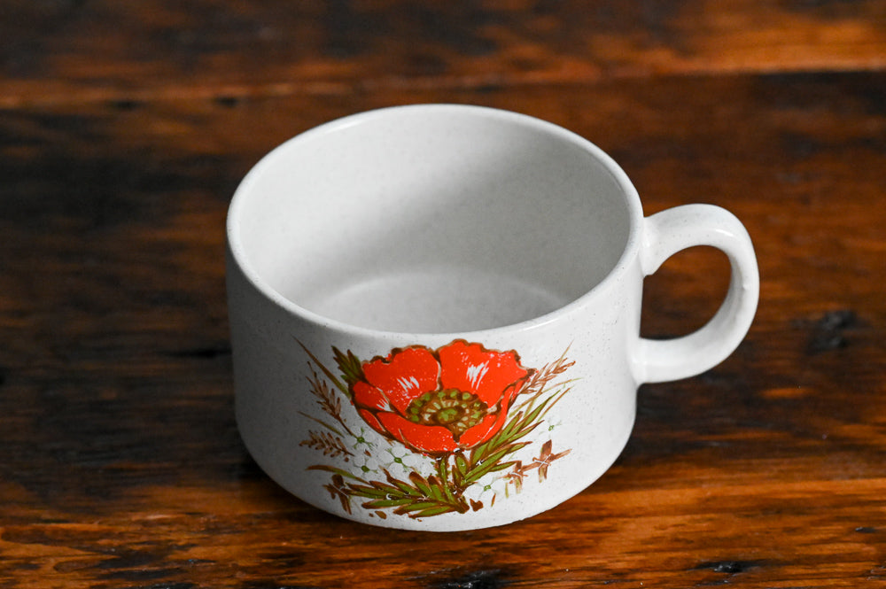 speckled stoneware mug with orange flower