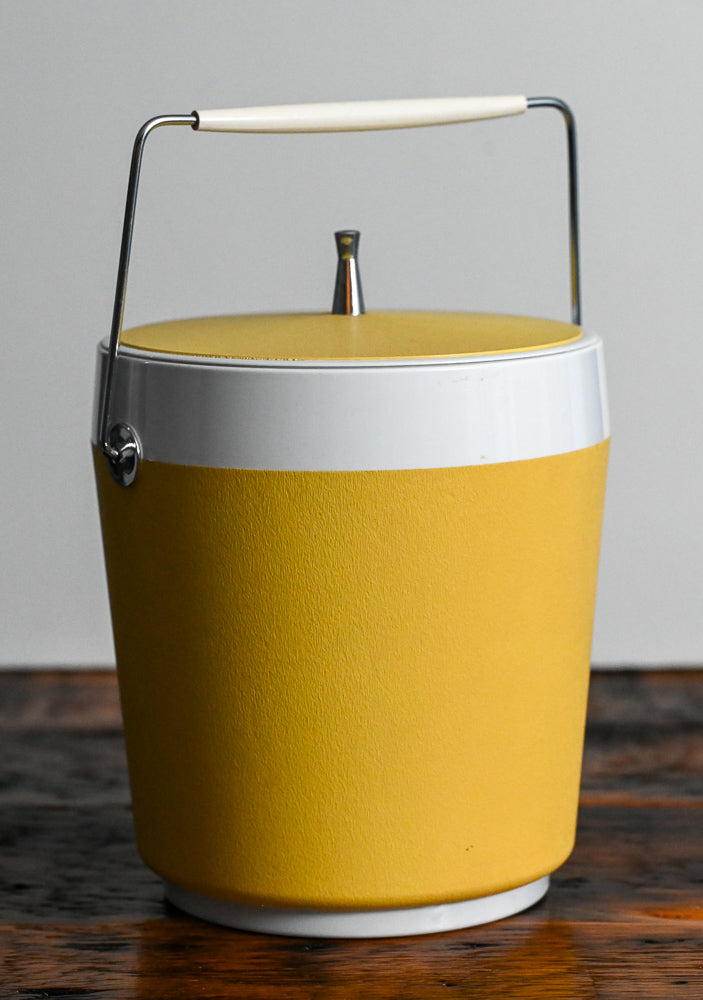 yellow and white West Bend ice bucket with lid and handle