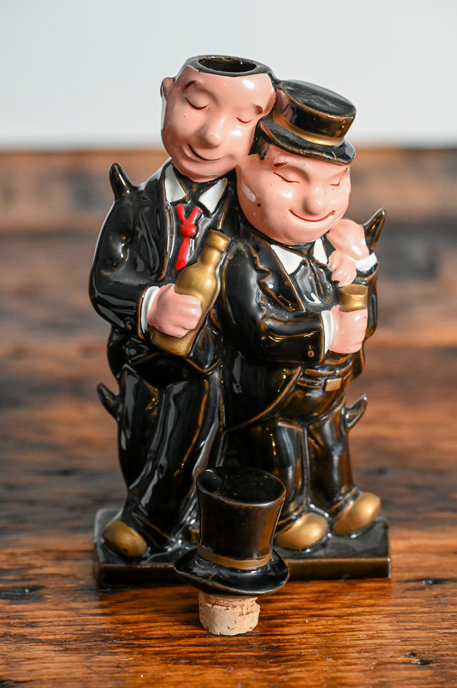 Laurel and Hardy shaped decanter with them wearting hats and suits