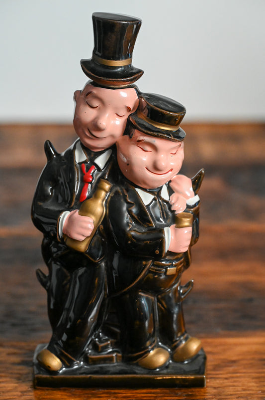 Laurel and Hardy shaped decanter with them wearting hats and suits