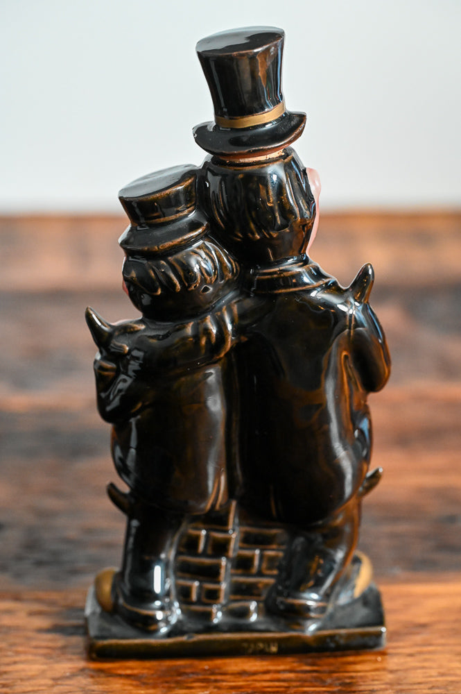 Laurel and Hardy shaped decanter with them wearting hats and suits