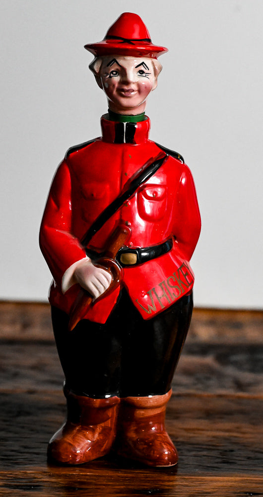 Canadian Mounted Police Decanter, stopper is the head with a hat, red suit