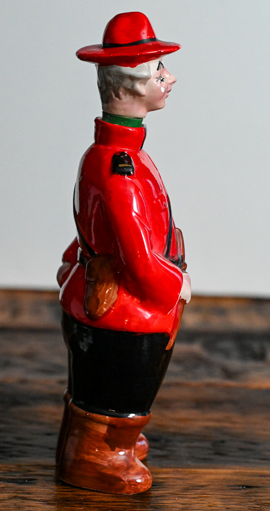 Canadian Mounted Police Decanter, stopper is the head with a hat, red suit