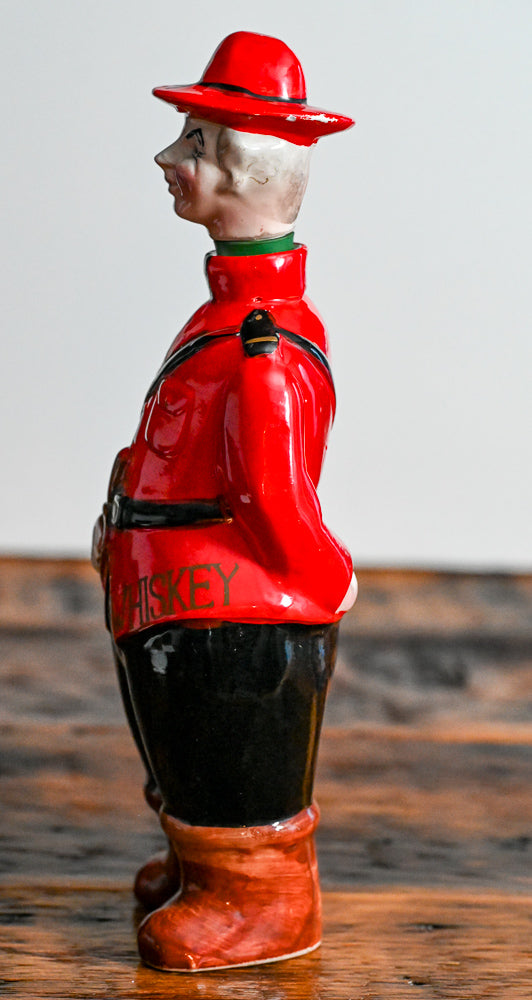 Canadian Mounted Police Decanter, stopper is the head with a hat, red suit