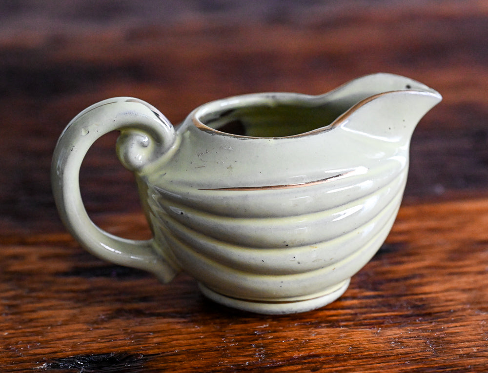 light green Enesco creamer with gold trim