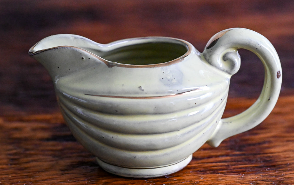 light green Enesco creamer with gold trim