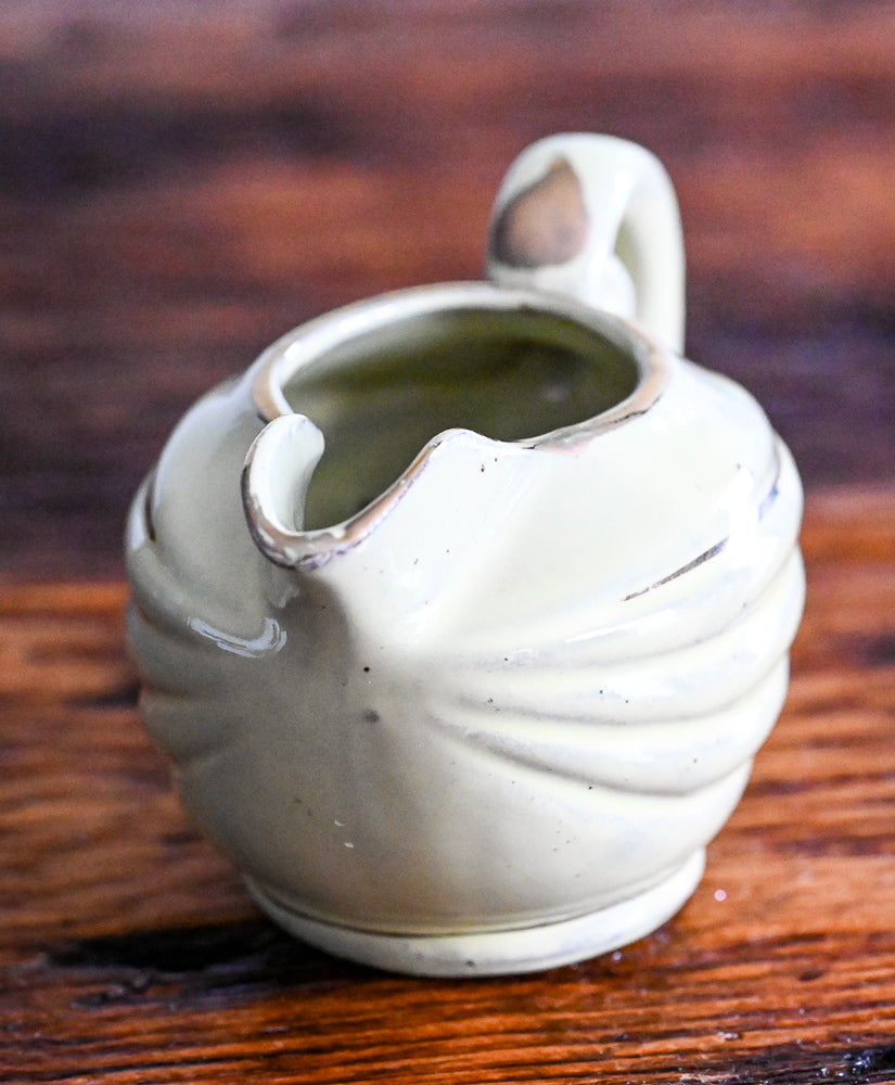 light green Enesco creamer with gold trim