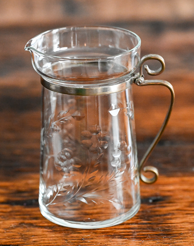 floral etched pitcher with brass handle and banding