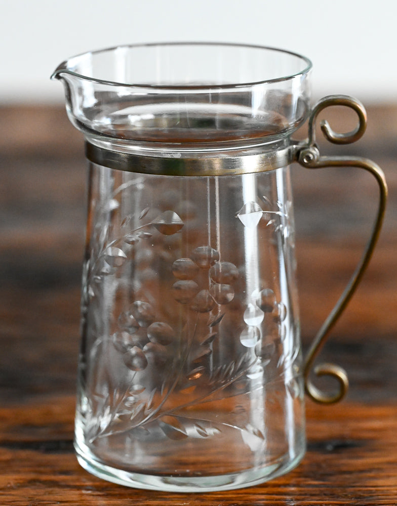 floral etched pitcher with brass handle and banding