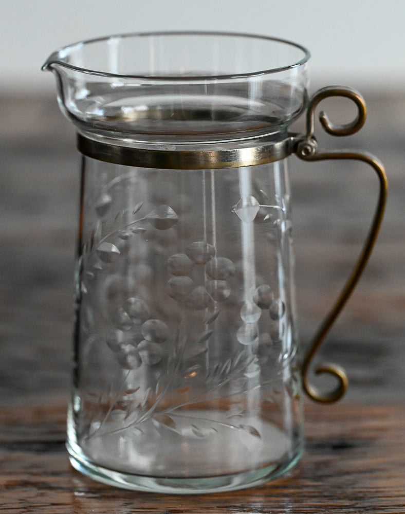 floral etched pitcher with brass handle and banding