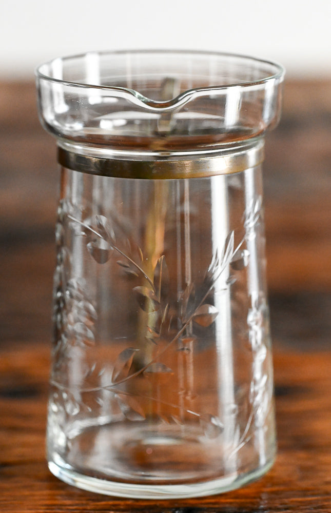 floral etched pitcher with brass handle and banding