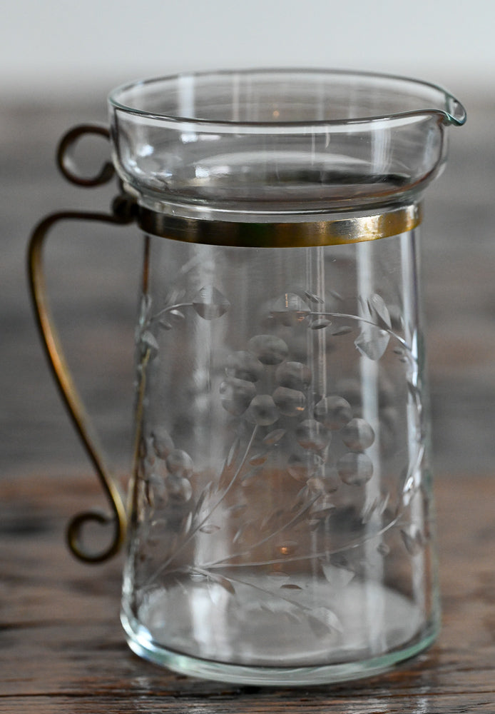 floral etched pitcher with brass handle and banding