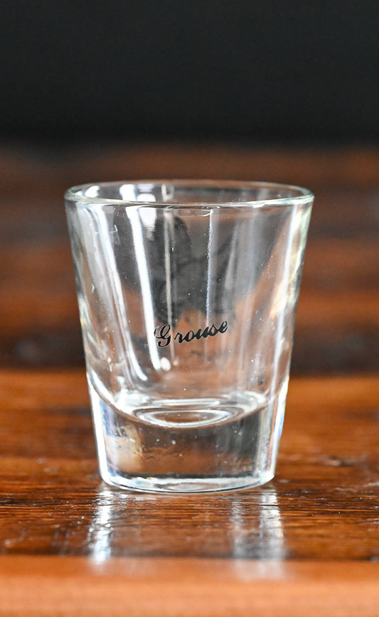 black print grouse on clear shotglass
