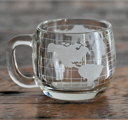 globe etched Nestle clear glass mug