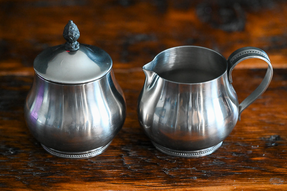 Stainless steel handled creamer and lidded sugar bowl