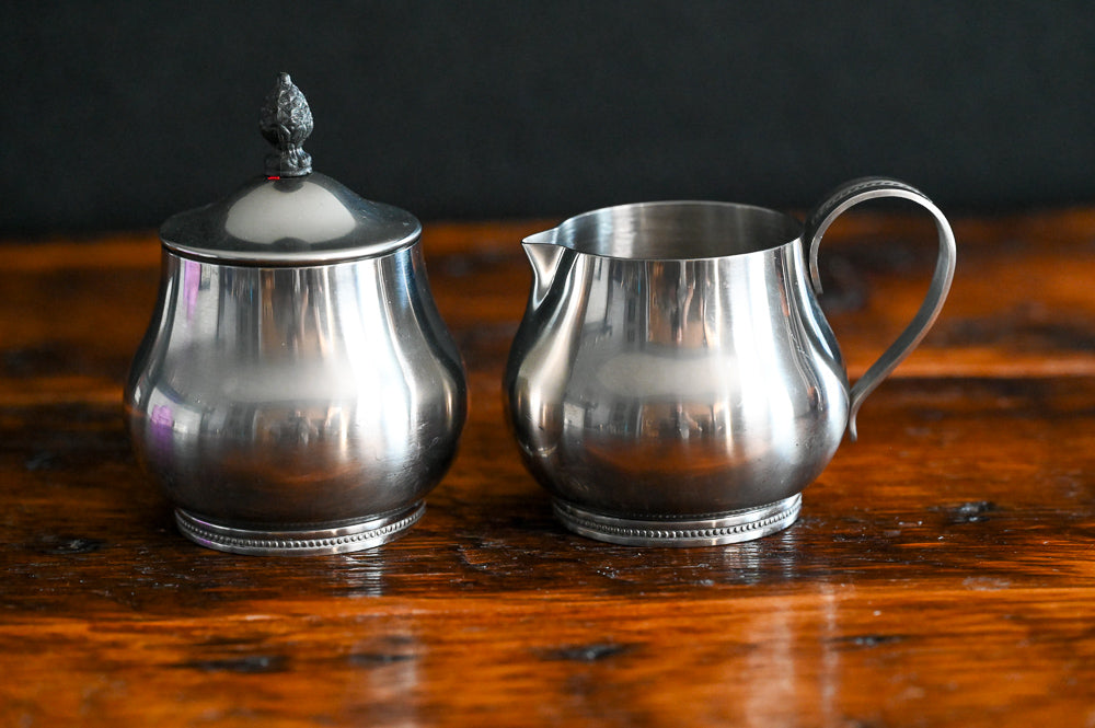 Stainless steel handled creamer and lidded sugar bowl