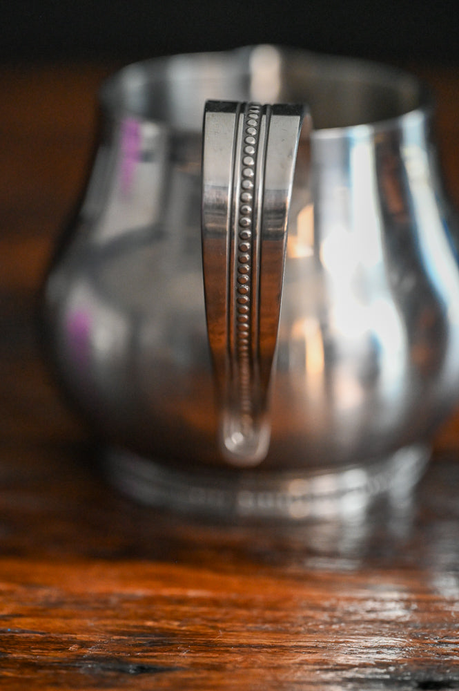 Stainless steel handled creamer and lidded sugar bowl