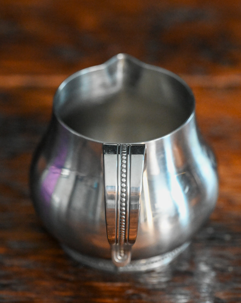 Stainless steel handled creamer and lidded sugar bowl