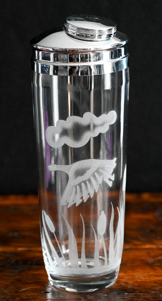 Etched duck, cloud and reeds on clear glass cocktail shaker with metal top