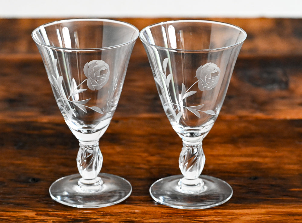Floral etched goblets on wood table