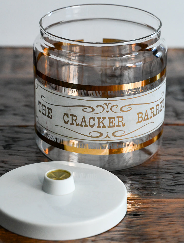 gold and white print Pyrex cracker barrel with lid