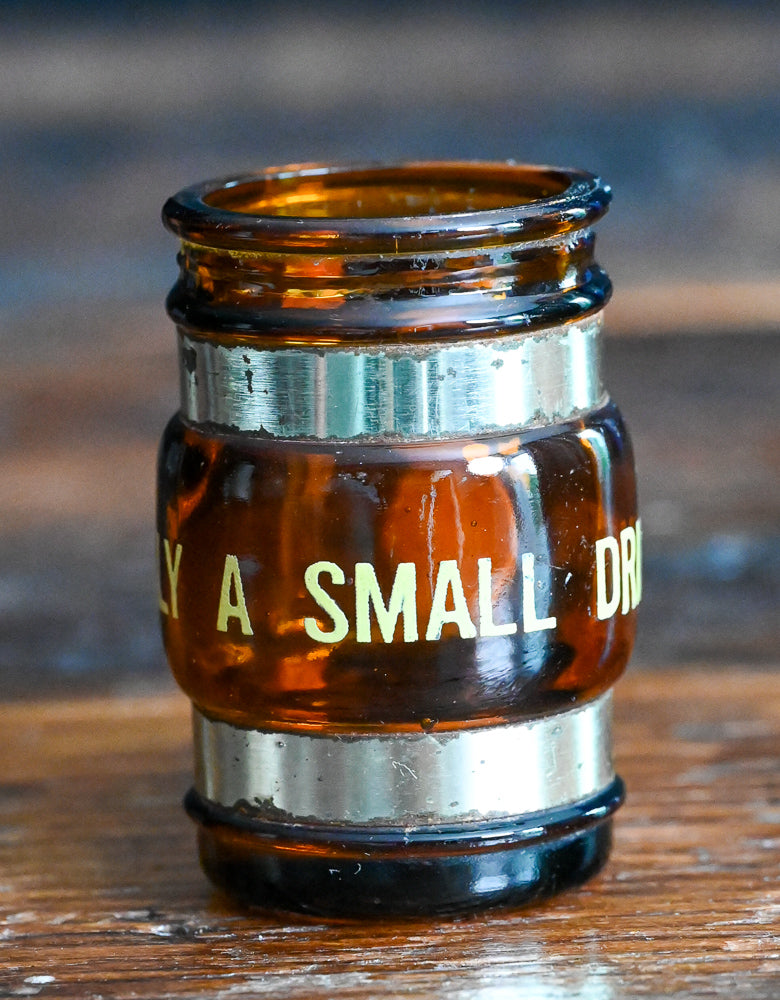 brown glass mug shotglass with wooden handle, says "small drinker"