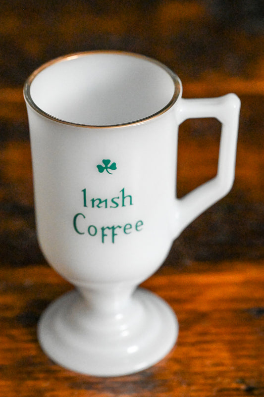 milk glass gold rim Irish coffee mug with green writing