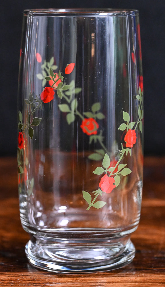 red roses on green vines on clear tall cooler glasses