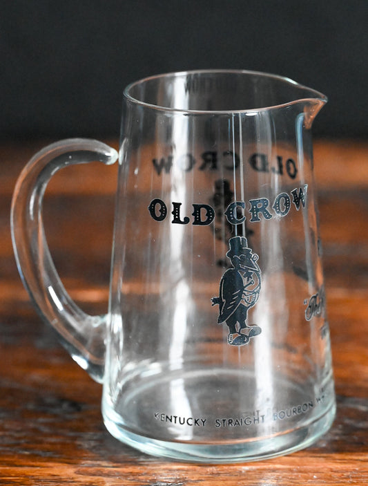 glass Old Crow pitcher with black writing and logo