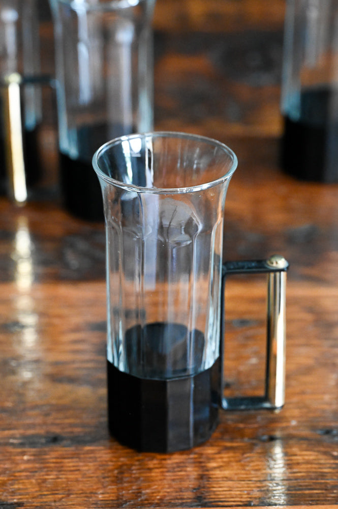 glass tumblers with black metal and brass handles