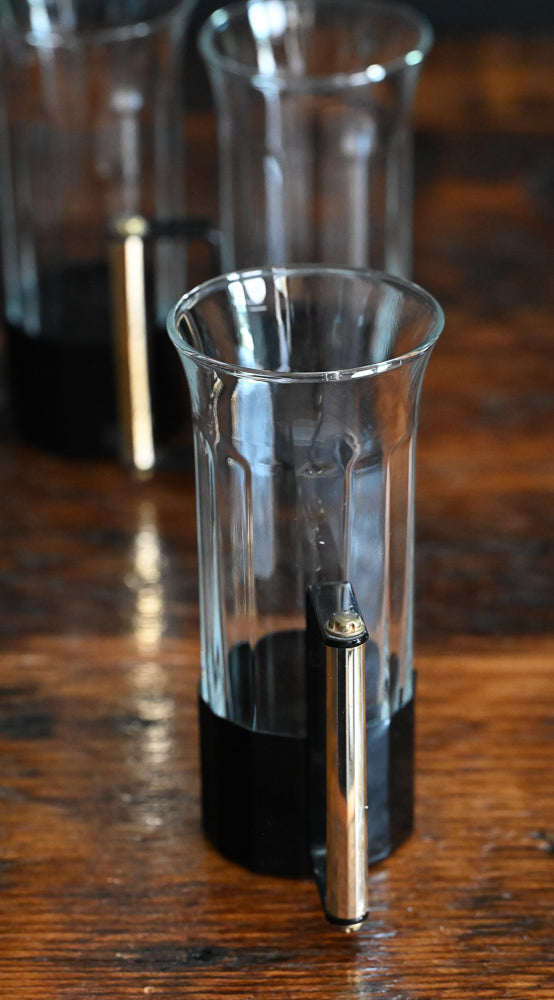 glass tumblers with black metal and brass handles