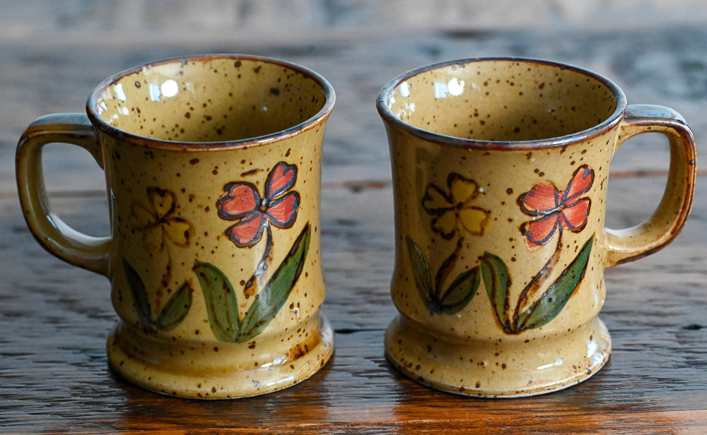 tan stoneware mugs with orange and yellow flowers