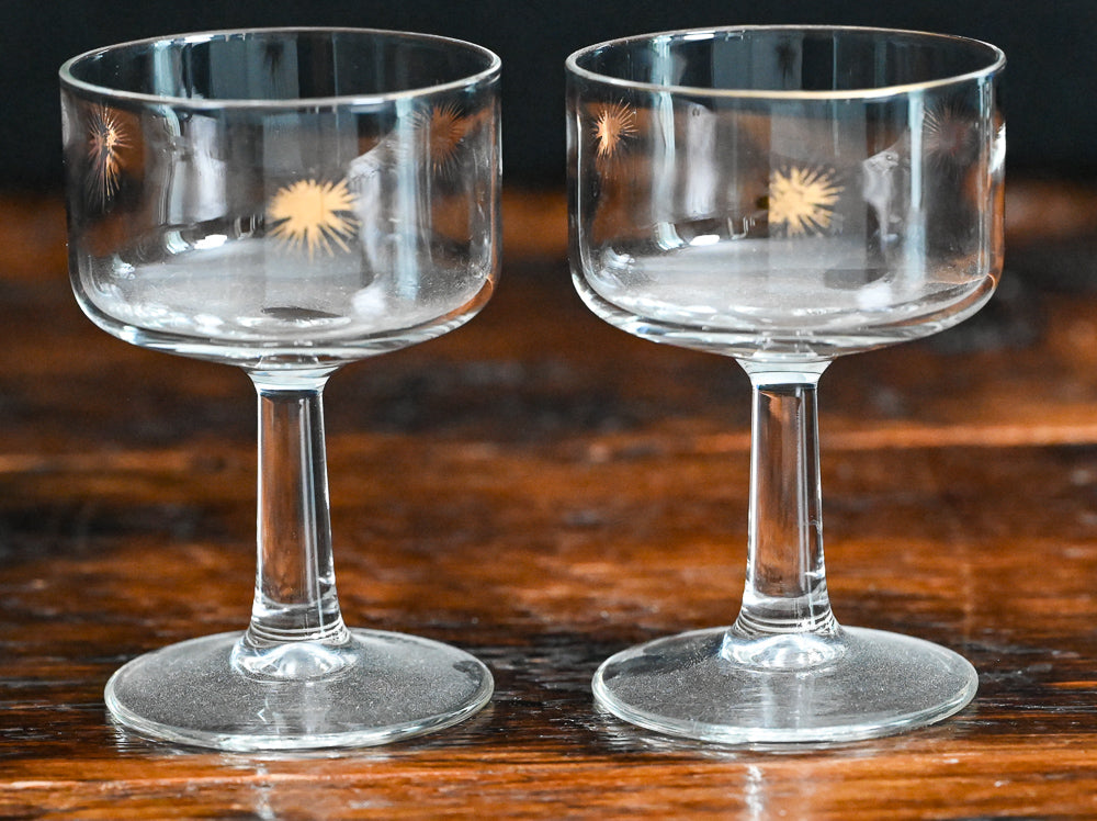 vintage clear cocktail coupes with gold starbursts