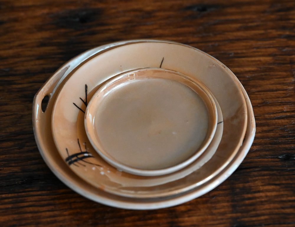 peach colored Japanese lusterware trinket dishes with white painted flowers