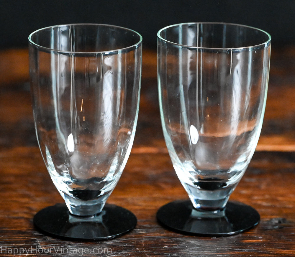 Clear tumbler with black glass foot