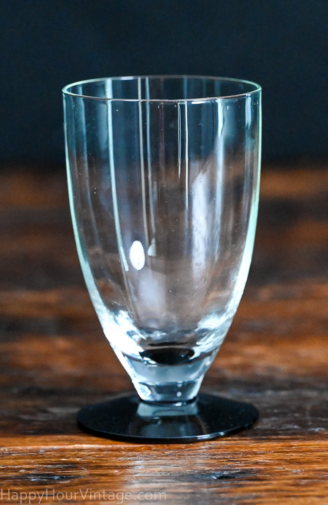 Clear tumbler with black glass foot