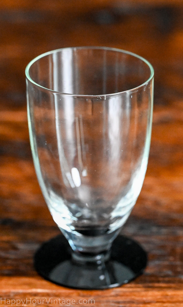 Clear tumbler with black glass foot