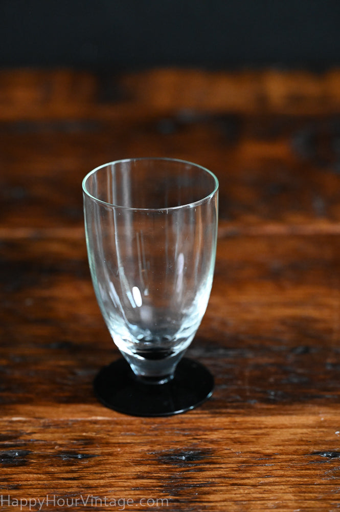 Clear tumbler with black glass foot