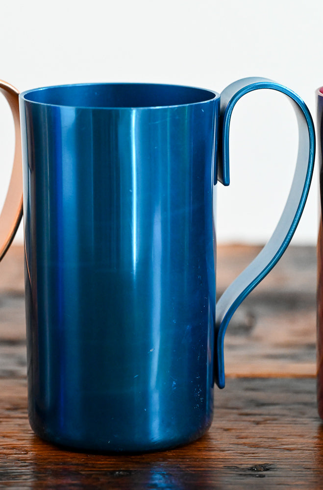 blue metal mug on wooden table